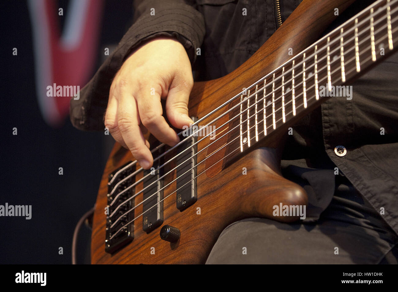 Bassist *** Local Caption *** guitar play, guitarist, stringed instrument, music instrument, instrument, strings, fingers, hand, pull, reach, practice Stock Photo