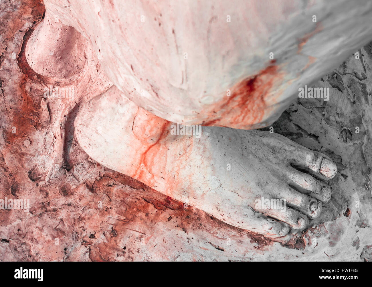 Extreme close-up of the feet of Jesus Christ bloodied. Top view. Shallow depth of field. Stock Photo