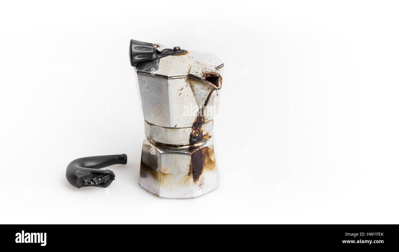 Vintage Moka pot forgotten on the fire. Burned with in molten plastic components. Stock Photo
