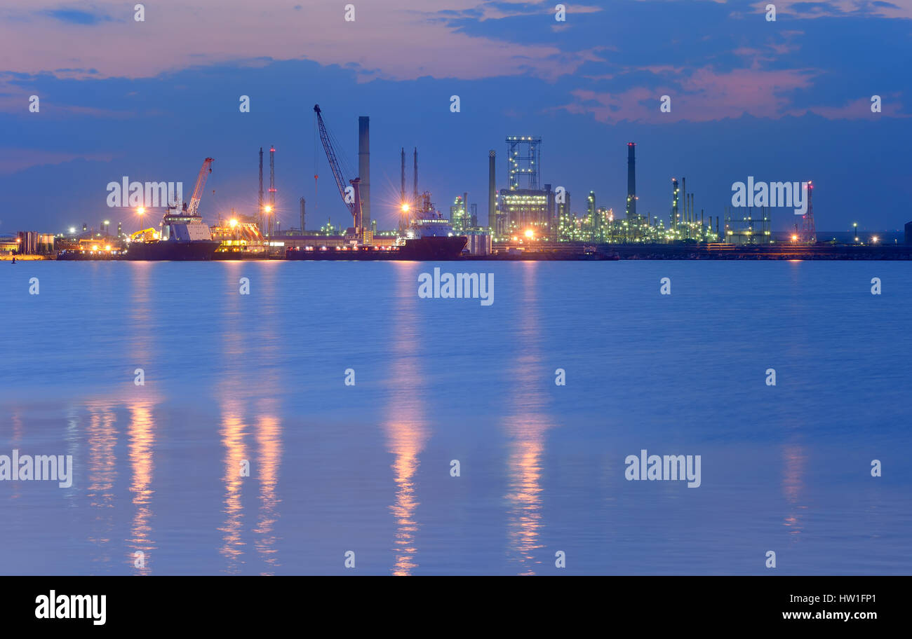 Industrial Petrochemical plant and sea in night time Stock Photo