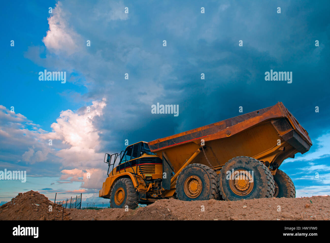 Yellow mining truck at work site before heavy storm Stock Photo