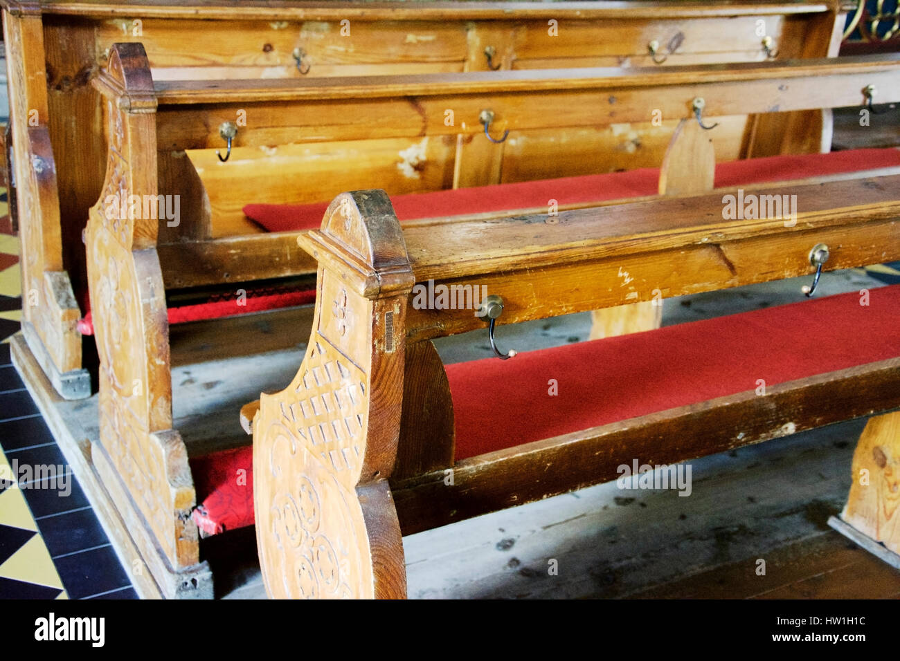 Wooden benches in a centuries-old church in Europe. Stock Photo