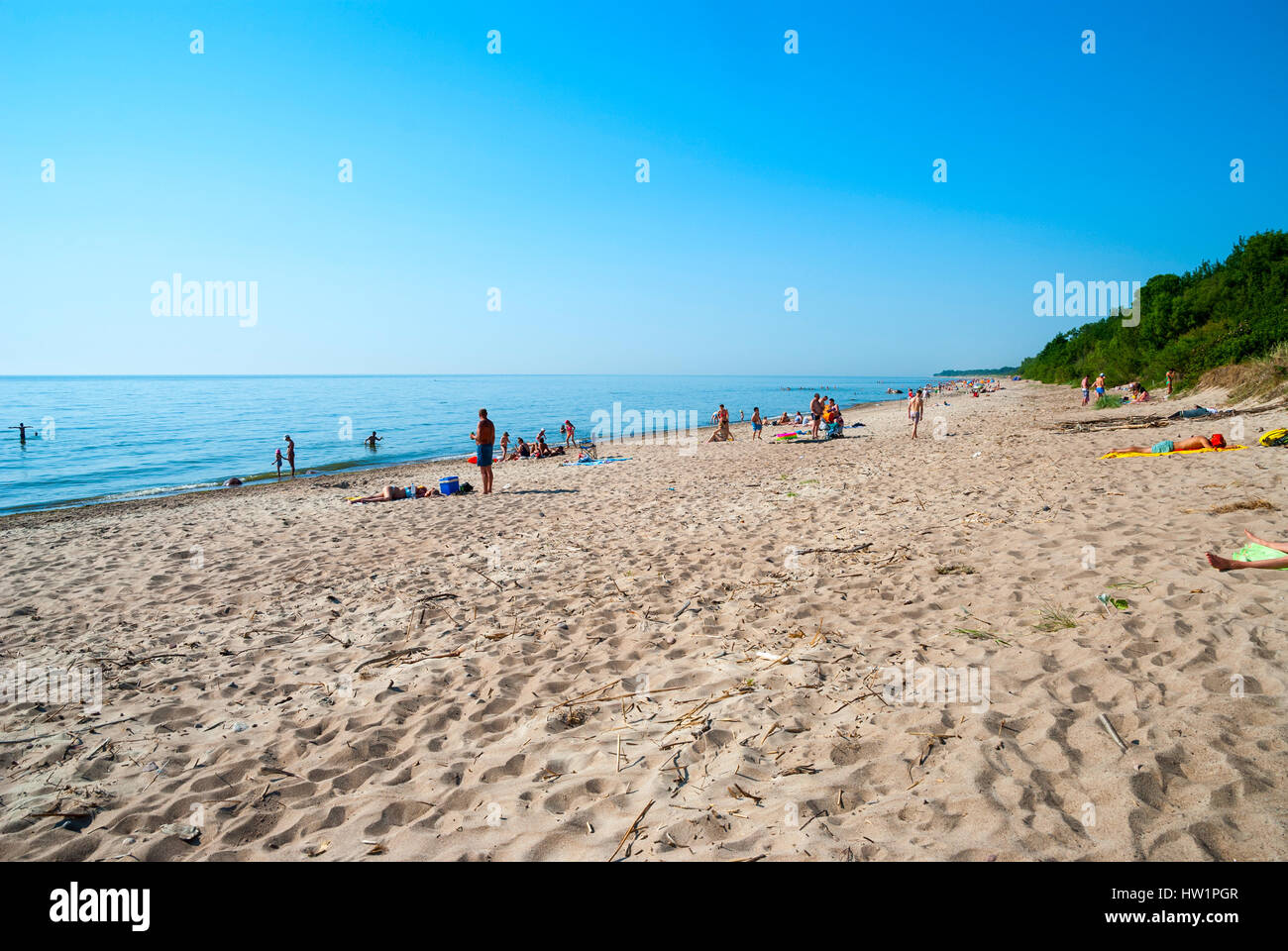 KLAIPEDA, LITHUANIA - JULY 4: People on sandy beach in Klaipeda under sunlight. July 2016. Stock Photo