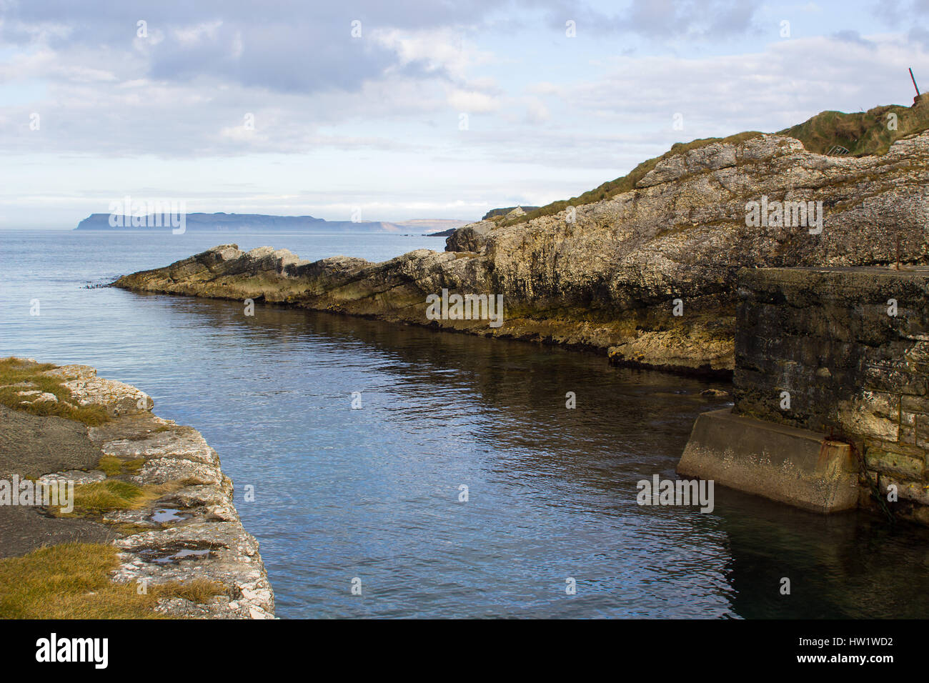 The narrow rocky entrance to the small harbor at Ballintoy on the North ...
