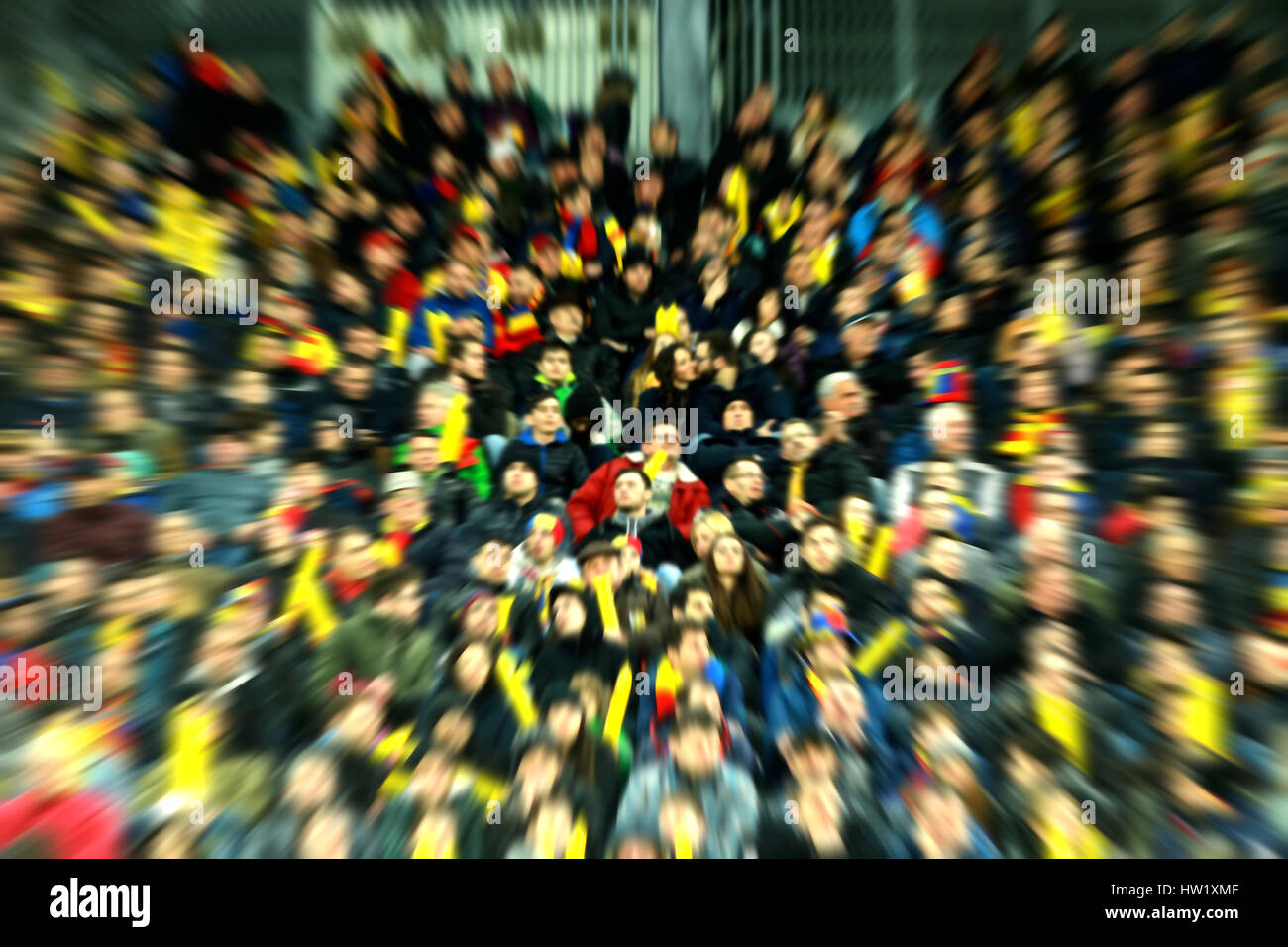Blurred, defocused fans on a stadium tribune. Zoom in lens effect Stock Photo