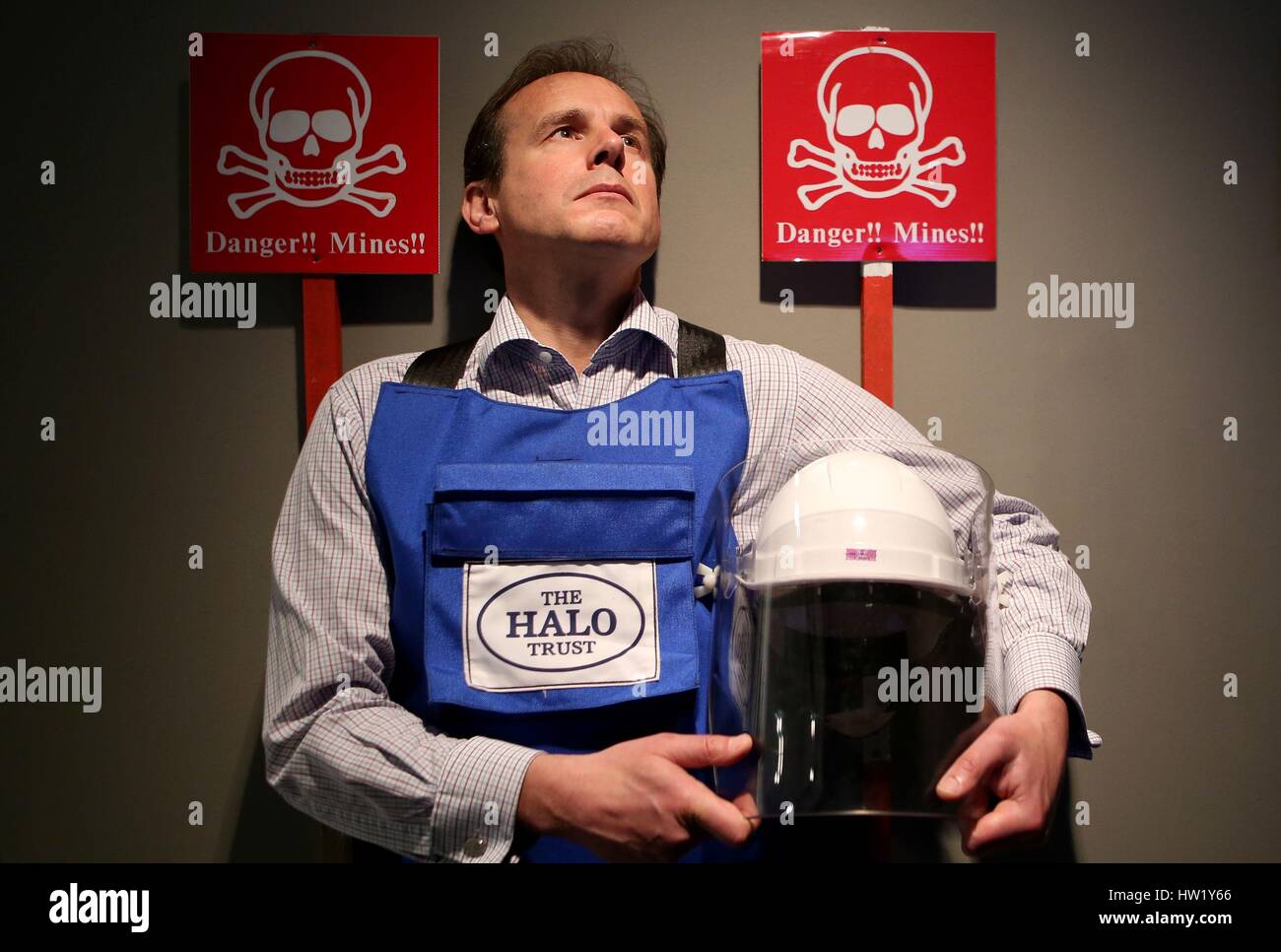 James Cowan, CEO of The Halo Trust, holds a protective helmet with face visor and wears a Kevlar-lined body armour apron which feature in the new exhibition at the National War Museum in Edinburgh called 'Safer Steps: The Work of the HALO Trust' which highlights the work undertaken by the world's largest humanitarian mine clearance organisation. Stock Photo
