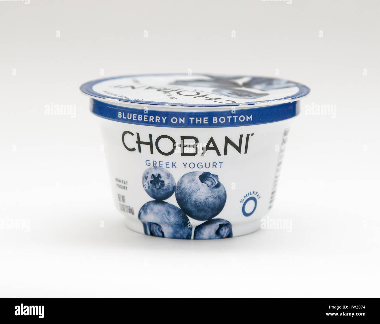 Container of blueberry Chobani Greek yogurt stands against white background. Stock Photo