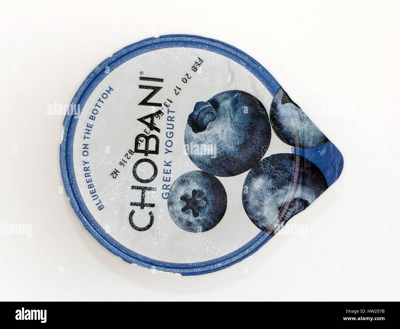 Top view of a container of blueberry Chobani Greek yogurt against white background. Stock Photo