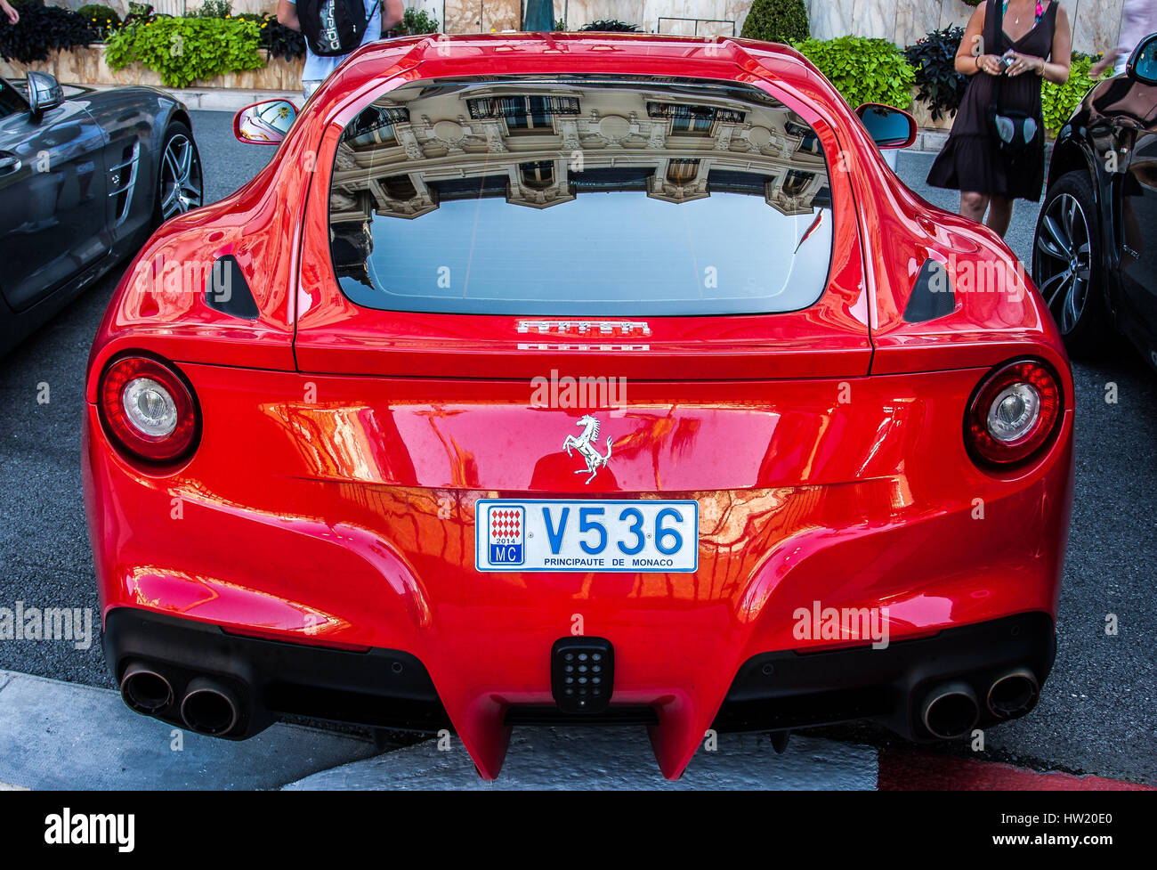 Red Ferrari Berlinetta is parked on a plaza near the Casino in Monte Carlo. Stock Photo