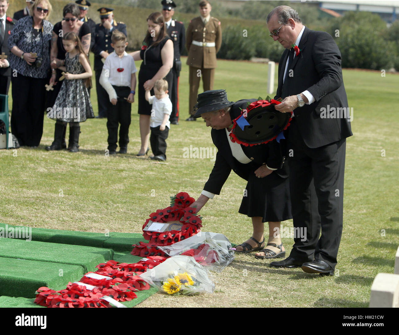 Lance Corporal Ronald George Blackham's sister Alma Williams and nephew Michael Blackham lay a wreath during the burial service for Lance Corporal Ronald George Blackham from Northwich, Cheshire and two unknown soldiers at the Commonwealth War Graves Commission (CWGC) Salerno War Cemetery, in Italy, who were all killed in WWII, during a fierce battle on 25 September 1943 on Hill 270, near the village of Capezzano. Stock Photo