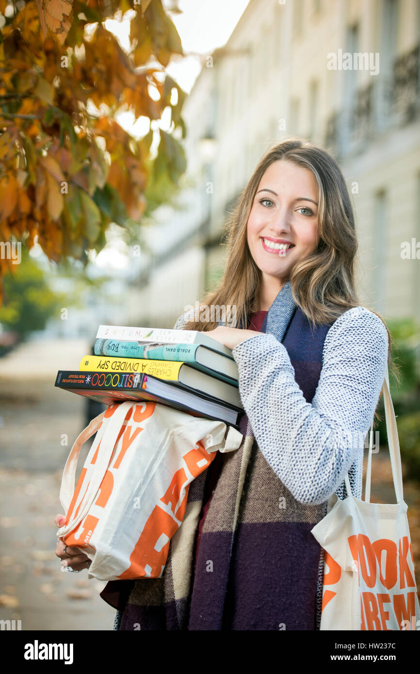 A festival organiser carrying books at the Sunday Times Cheltenham Literature Festival Oct 2016 Stock Photo