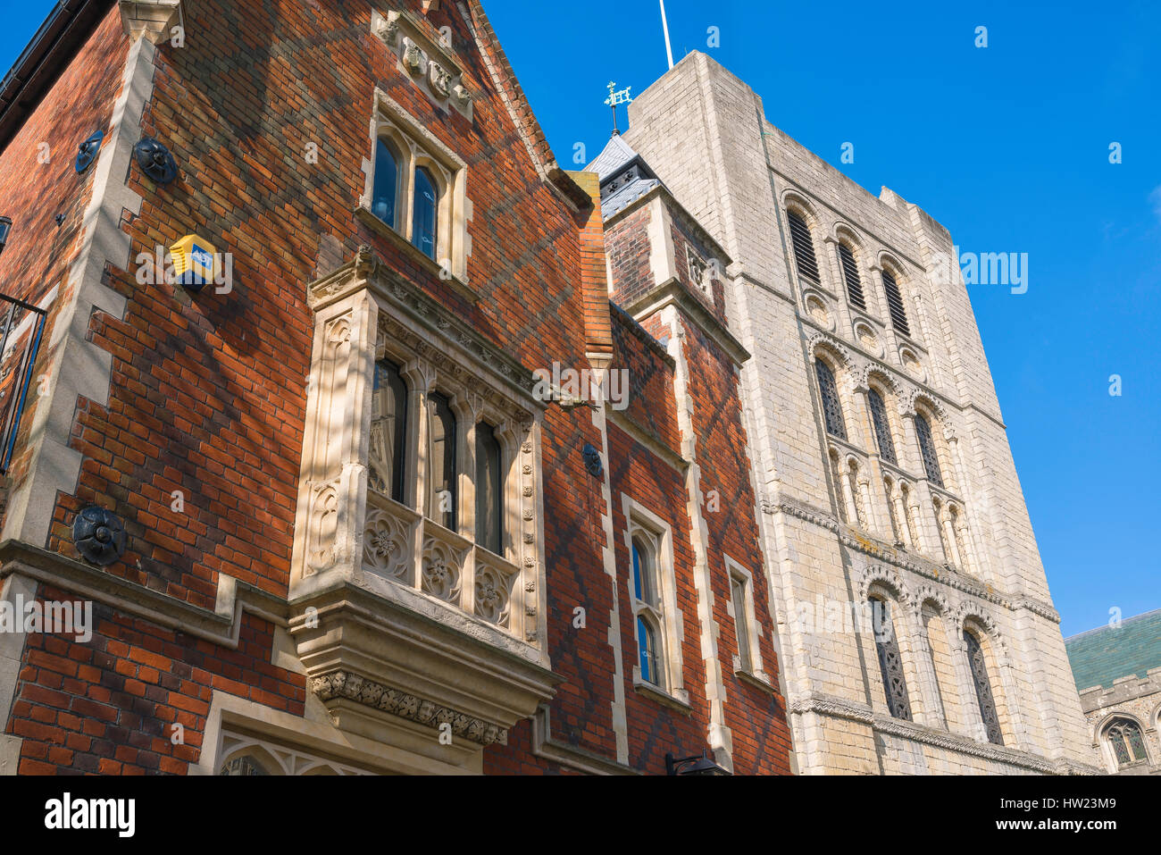 Suffolk architecture, the 'Tudor-Gothic' Savings Bank House(designed by  Lewis Nockalls Cottingham) and  11th century Norman tower, Bury St Edmunds. Stock Photo