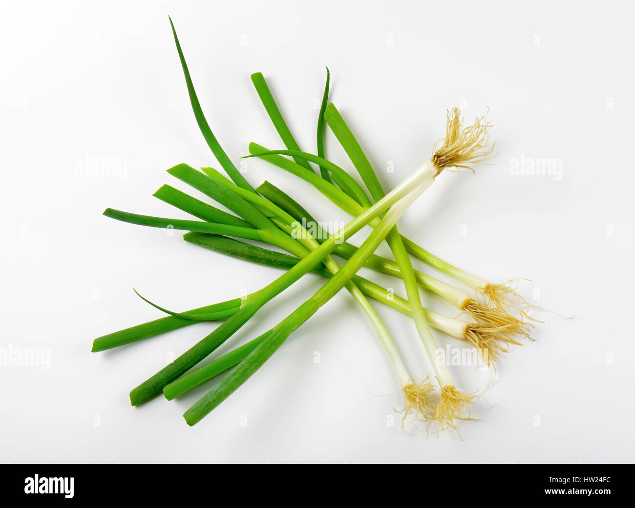 Fresh green onions on white background Stock Photo - Alamy