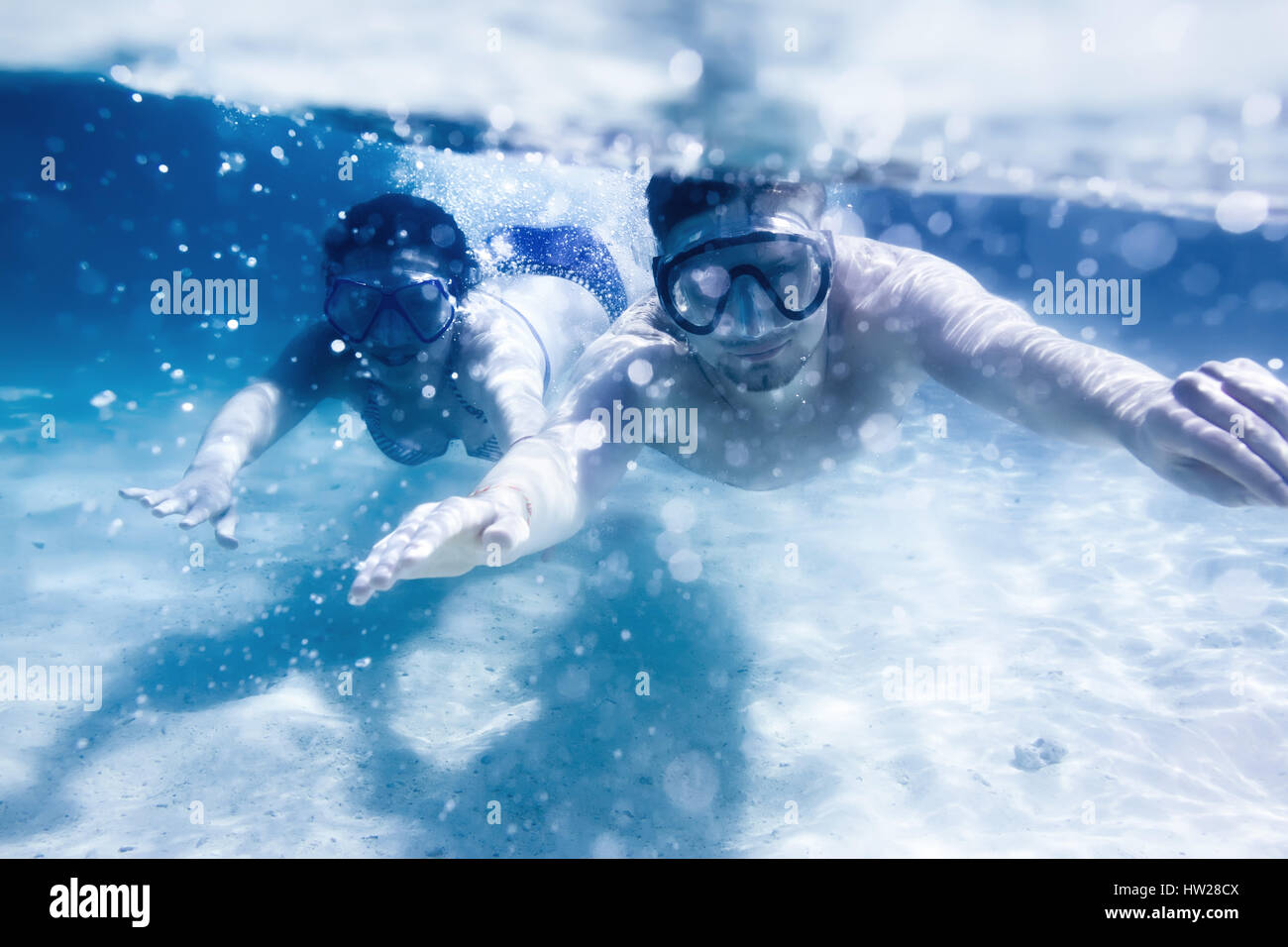 Couple swims or snorkeling underwater Stock Photo