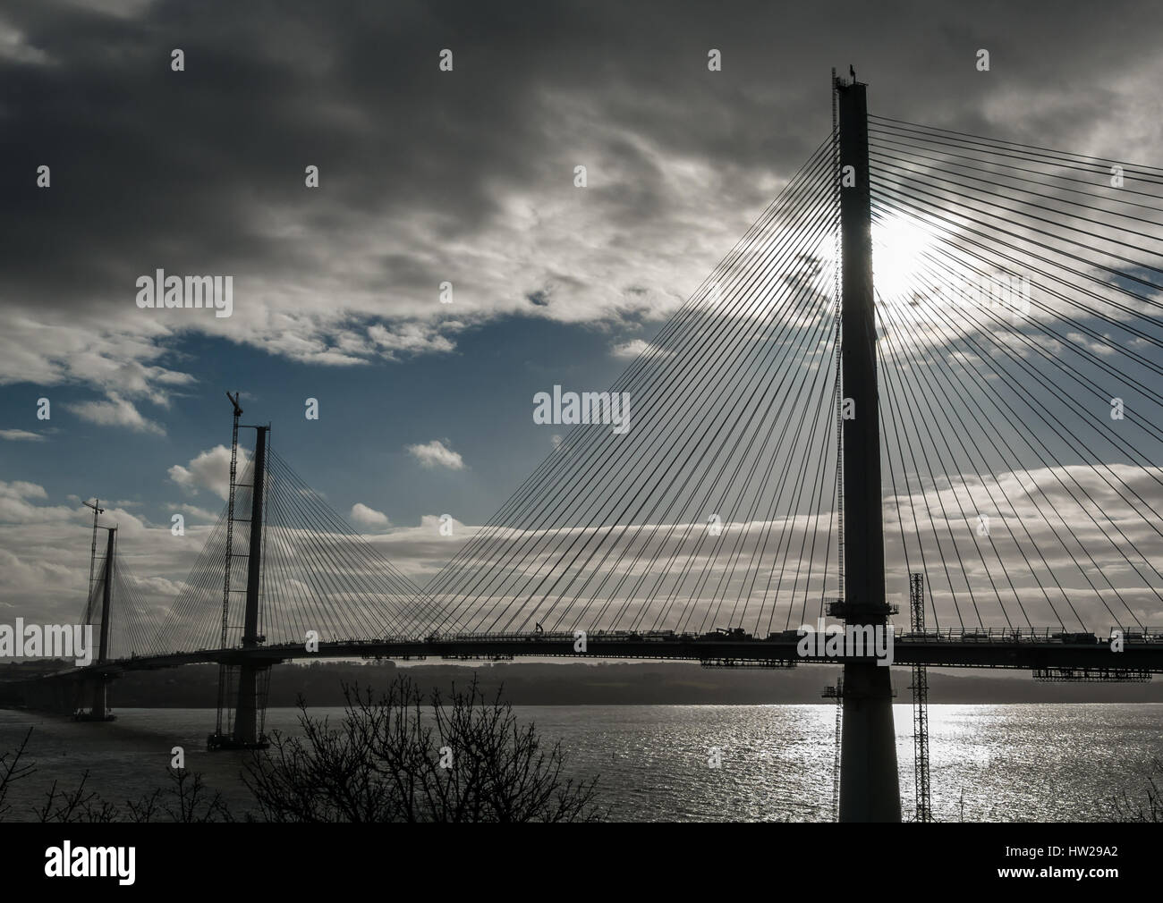 Silhouette of new Queensferry Crossing bridge under construction nearing completion in 2017, dusk view from Fife, Scotland, UK Stock Photo