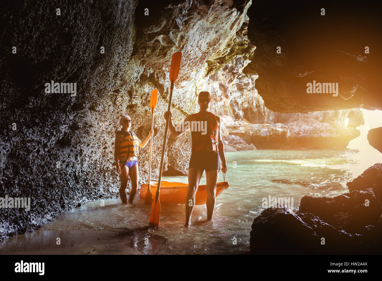 Couple of kayakers in sea cave Stock Photo