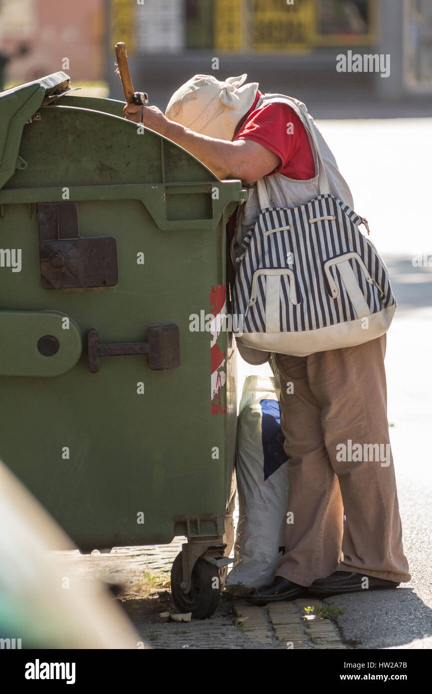 homeless woman digging in trash Stock Photo Alamy