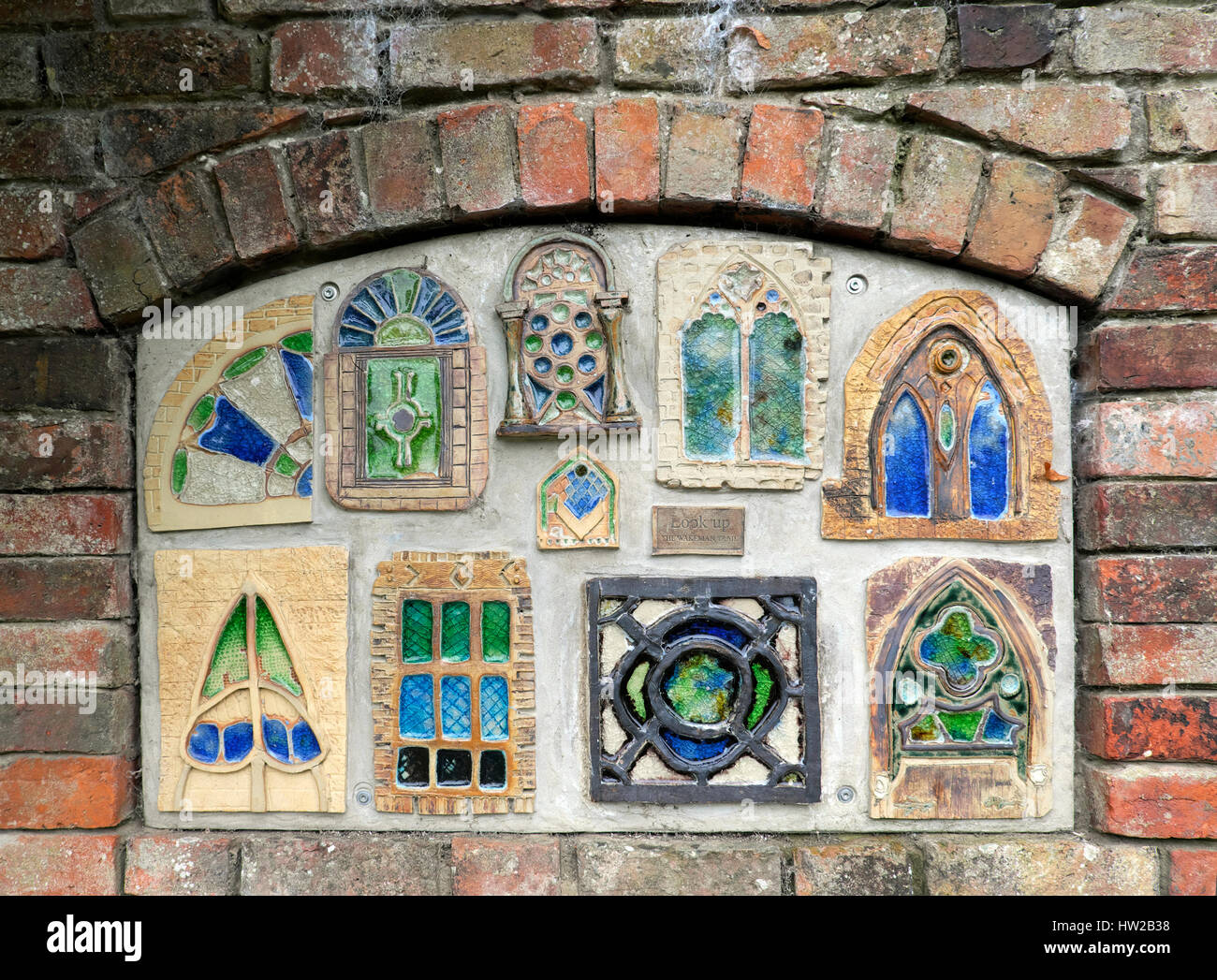 Handmade tiles in the Severn River brick wall along the Wakeman Art Trail in Shrewsbury, Shropshire, UK  KATHY DEWITT Stock Photo