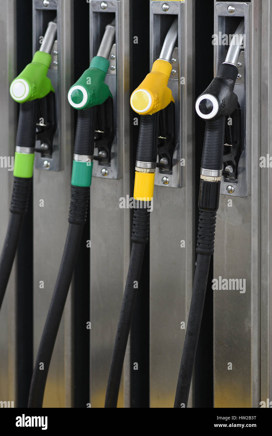 Nozzles on a fuel dispenser machine at a petrol station Stock Photo
