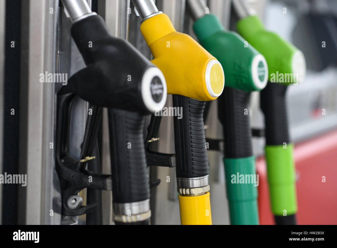 Nozzles on a fuel dispenser machine at a petrol station Stock Photo