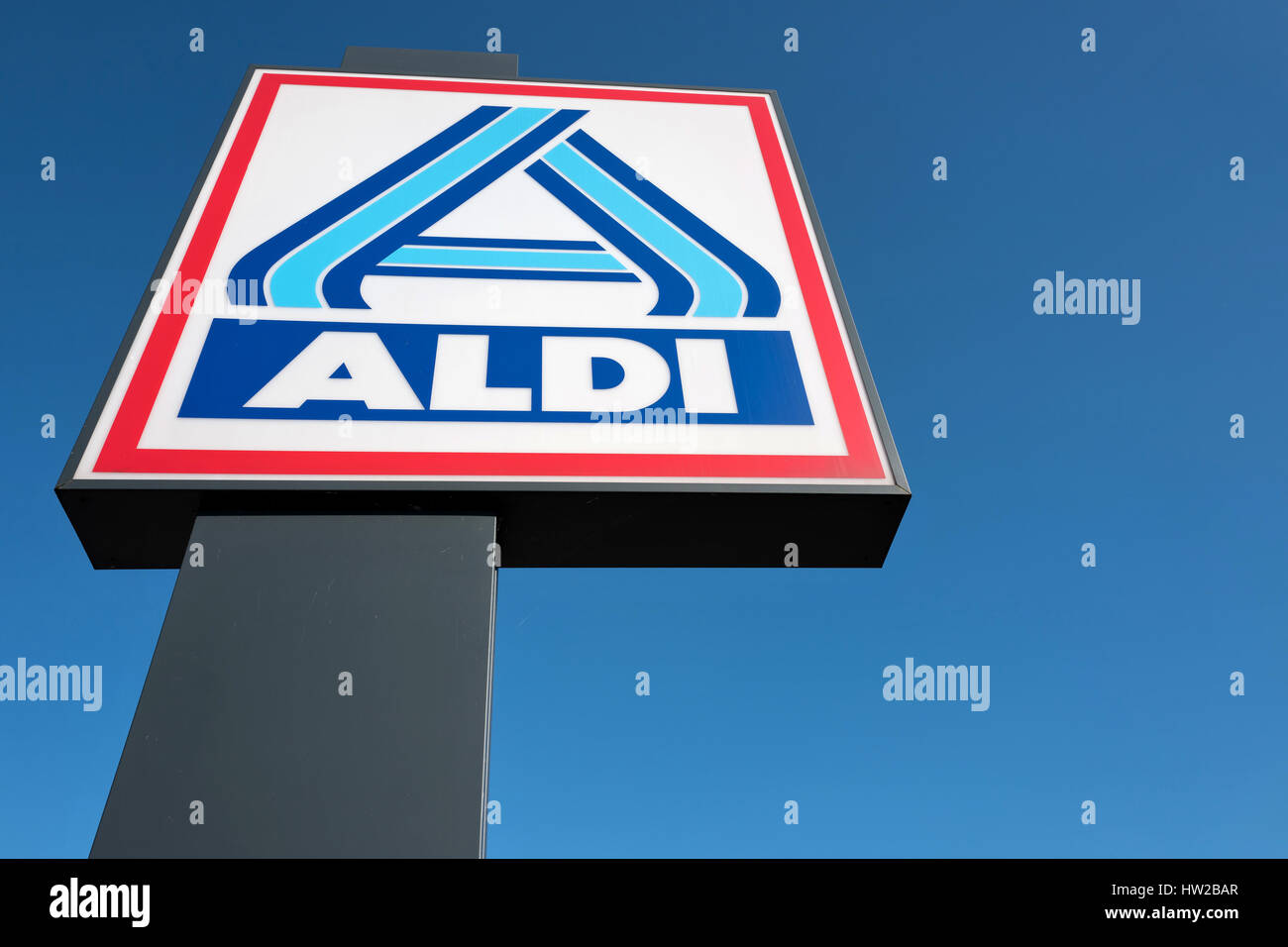Aldi sign (north division) against blue sky. Aldi is a leading global