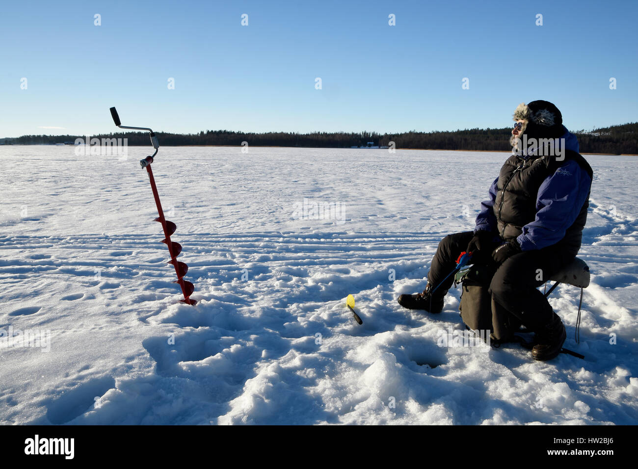 Ice fisherman sitting on bucket hi-res stock photography and images - Alamy