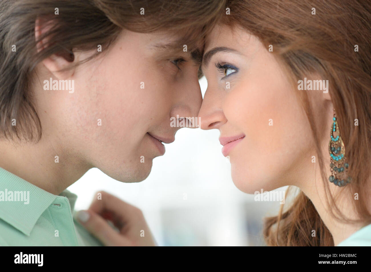 Beautiful young couple hugging Stock Photo - Alamy