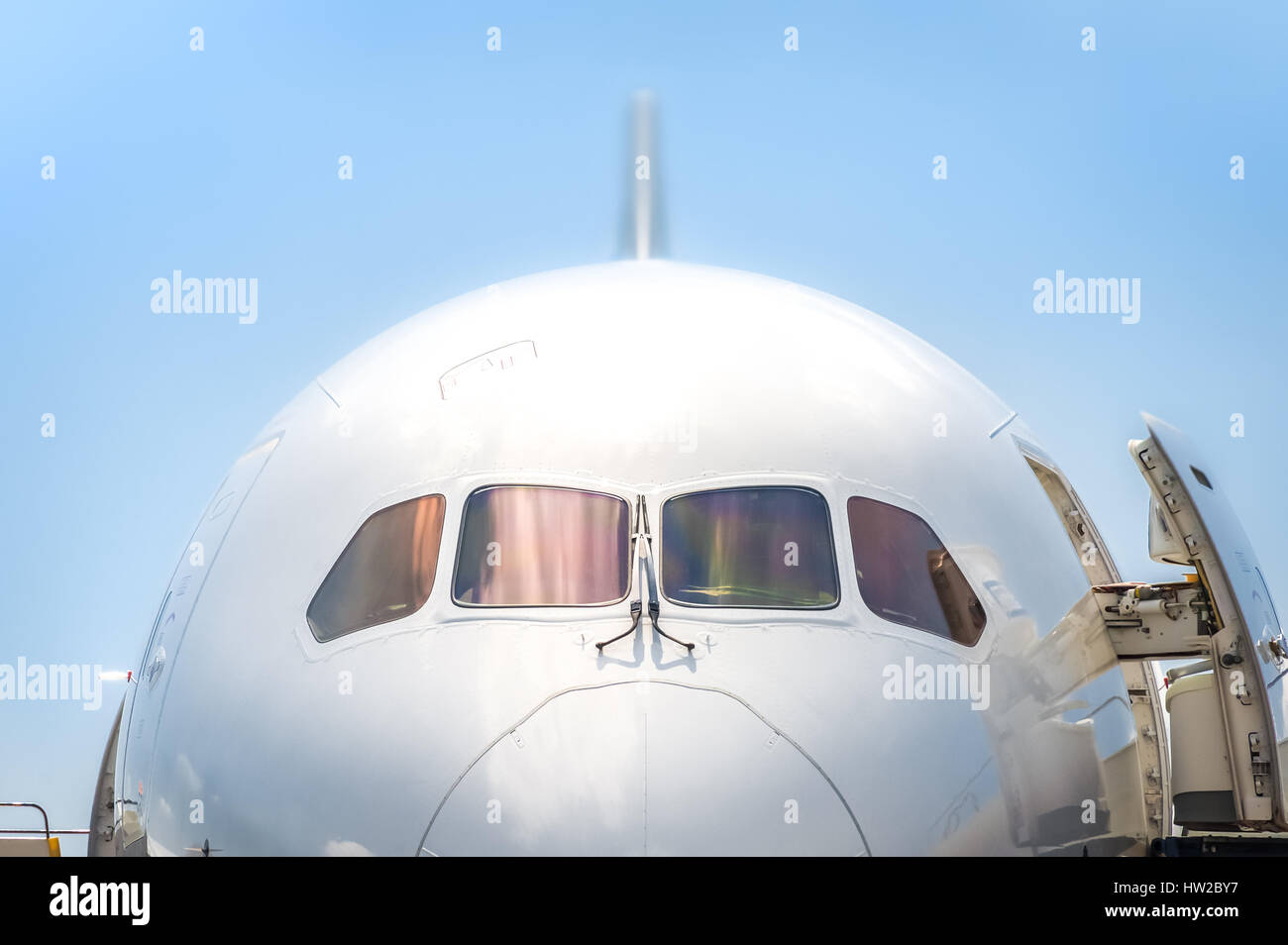 closeup of a passenger jet nosecone and cockpit with doors open Stock Photo