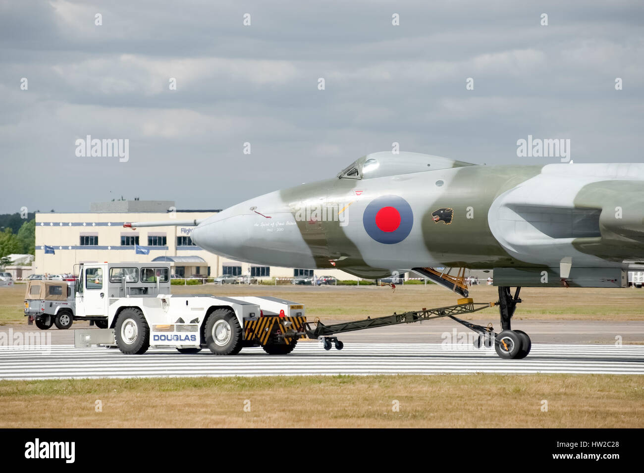 Vulcan bomber XH558 being towed by an airfield tug truck at the Farnborough Airshow, UK Stock Photo