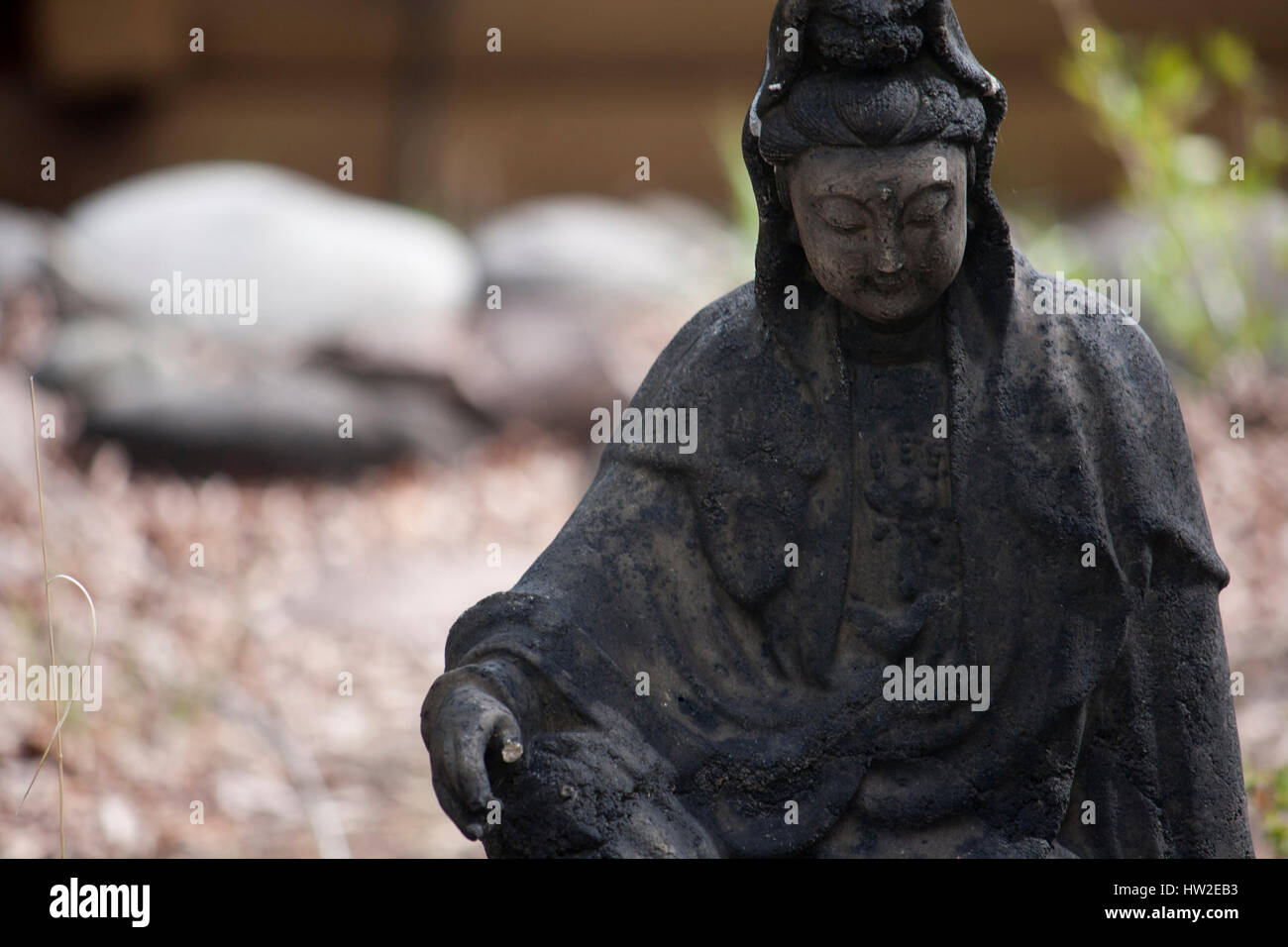 Small stone statue of Buddha in garden Stock Photo Alamy