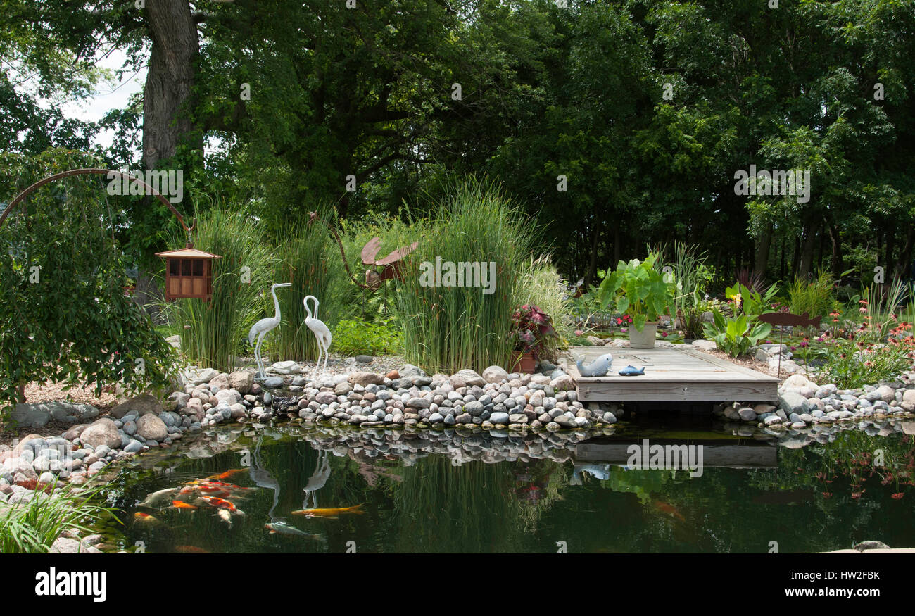 Water Garden With Dock And Automatic Koi Feeder Stock Photo
