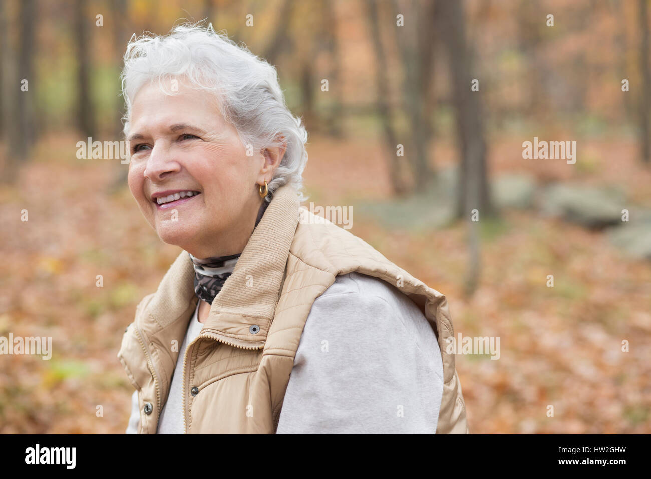 Caucasian woman smiling outdoors in autumn Stock Photo