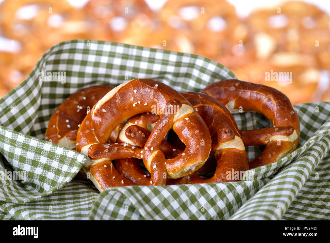 Fresh handmade original Bavarian pretzels from the domestic master baker on a green checkered