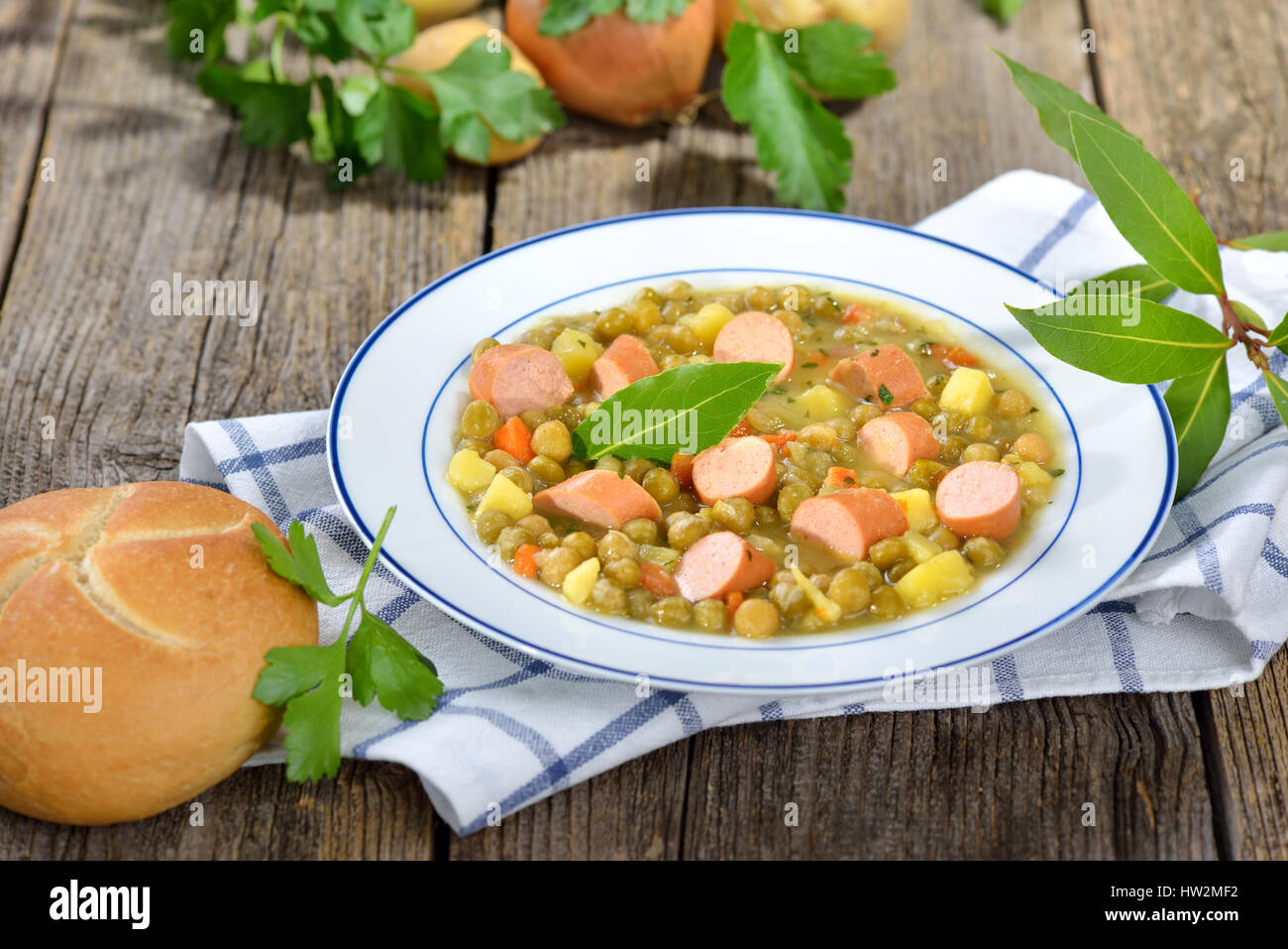 Hearty pea stew with potatoes, bacon and Vienna sausages Stock Photo
