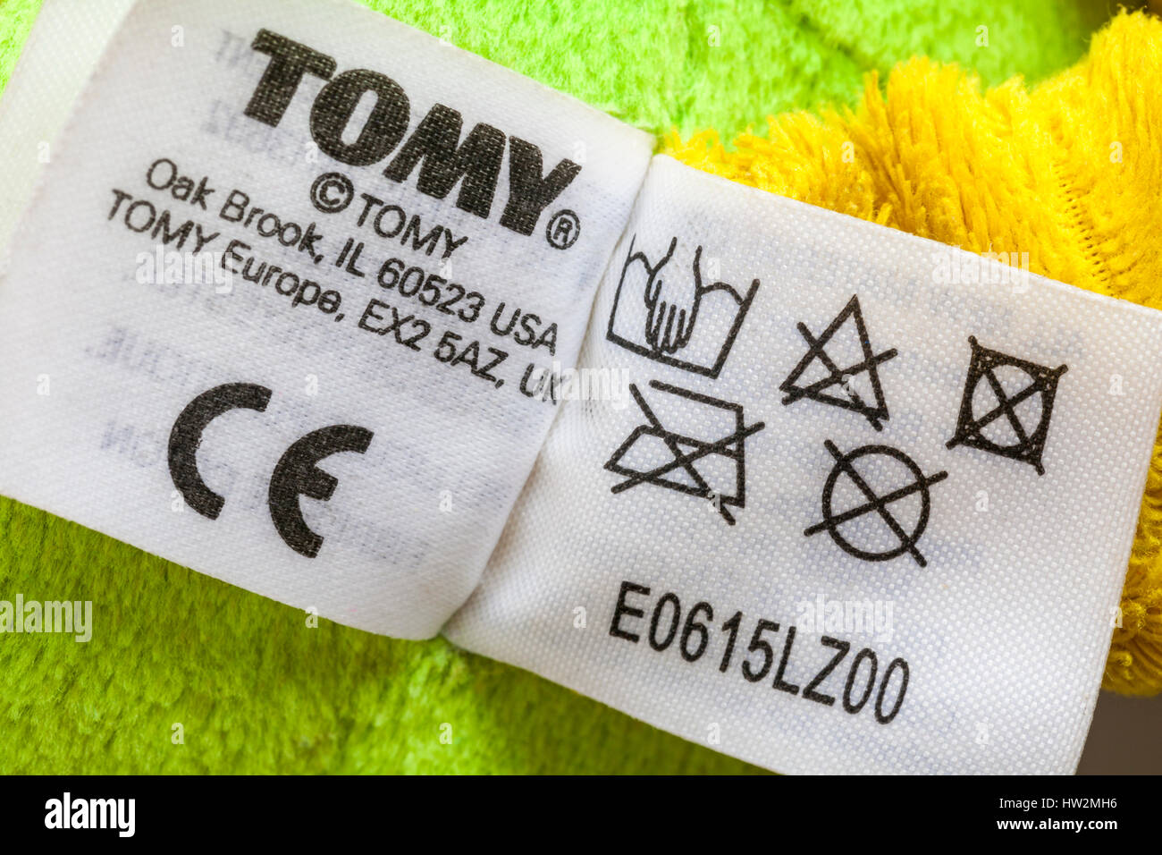 Information on label on Tomy Lamaze Rusty the Robot toy showing washing care instructions symbols and CE symbol Stock Photo