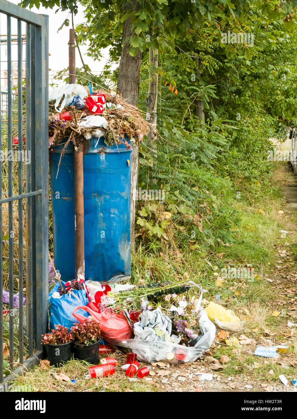 https://c8.alamy.com/comp/HW2T3R/overfilled-trash-container-at-the-entrance-of-a-romanian-cemetery-HW2T3R.jpg