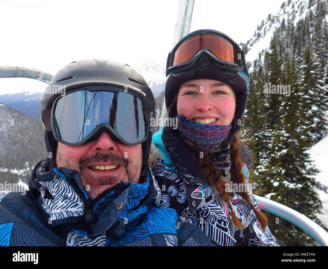 Father and daughter selfie on chairlift Stock Photo