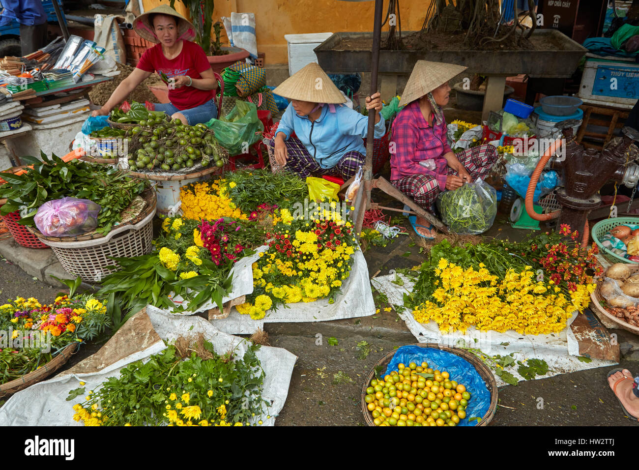 Women selling flowers, Hoi An (UNESCO World Heritage Site), Vietnam Stock Photo