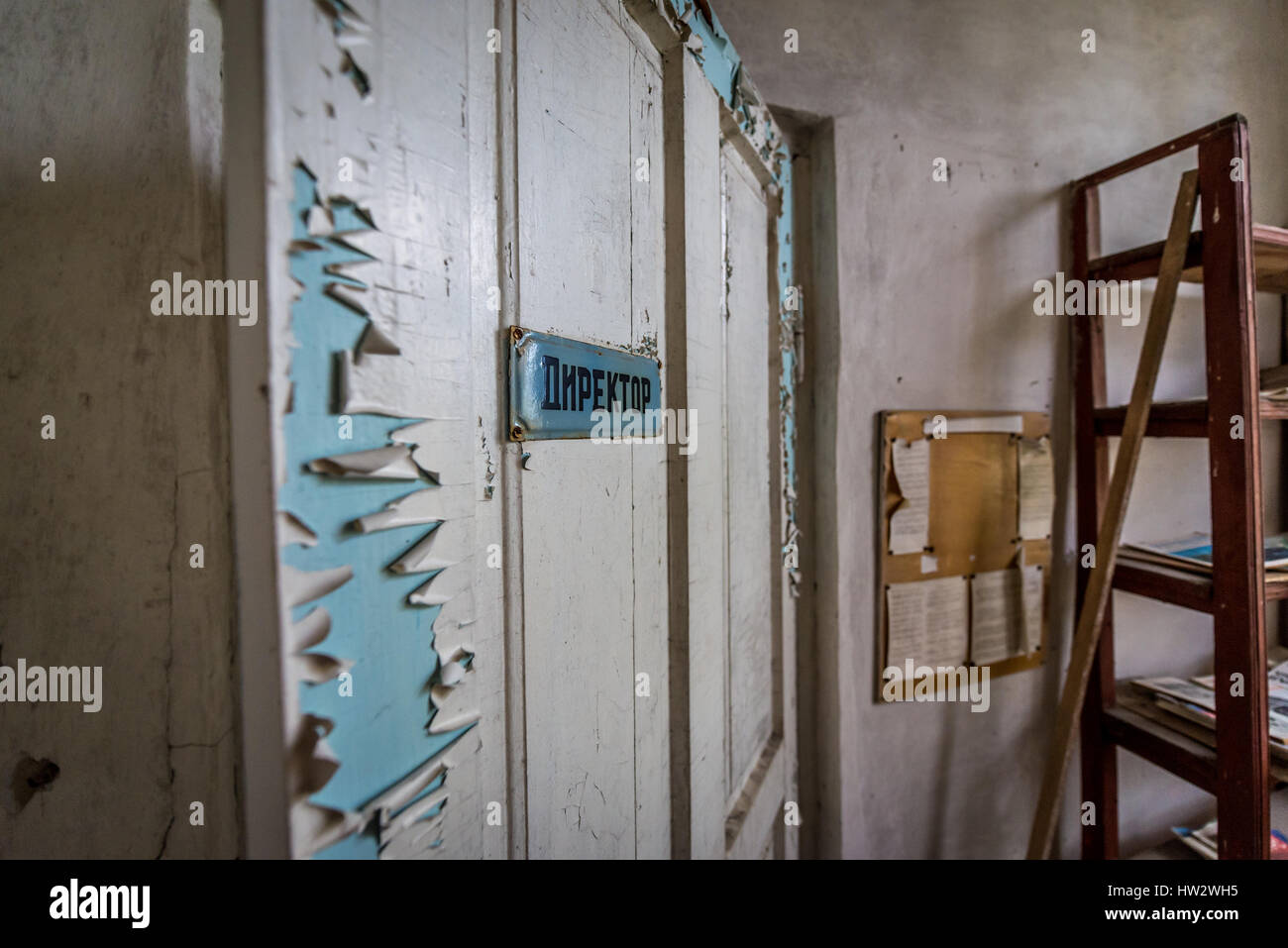 Door of headmaster office in secondary school in Mashevo abandoned village of Chernobyl Nuclear Power Plant Zone of Alienation in Ukraine Stock Photo