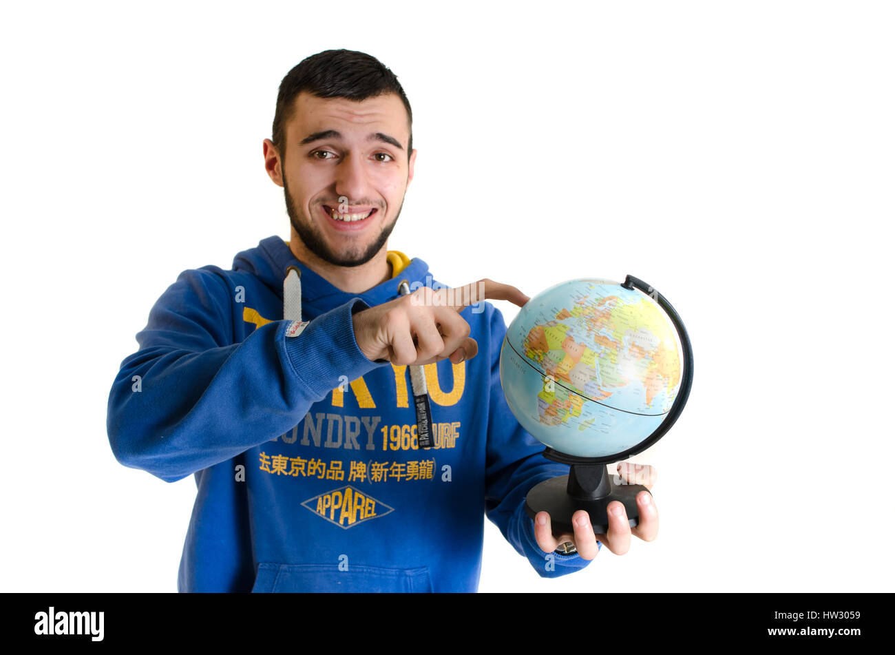Teenager man with earth globe confused choosing a destination isolated on white backgroud Stock Photo