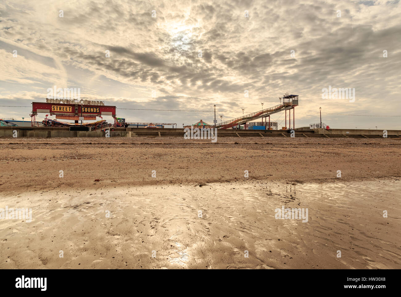 HUNSTANTON, ENGLAND - MARCH 10: Hunstanton fairground from the beach as sunset approaches. HDR image. In Hunstanton, Norfolk, England. On 10th March 2 Stock Photo