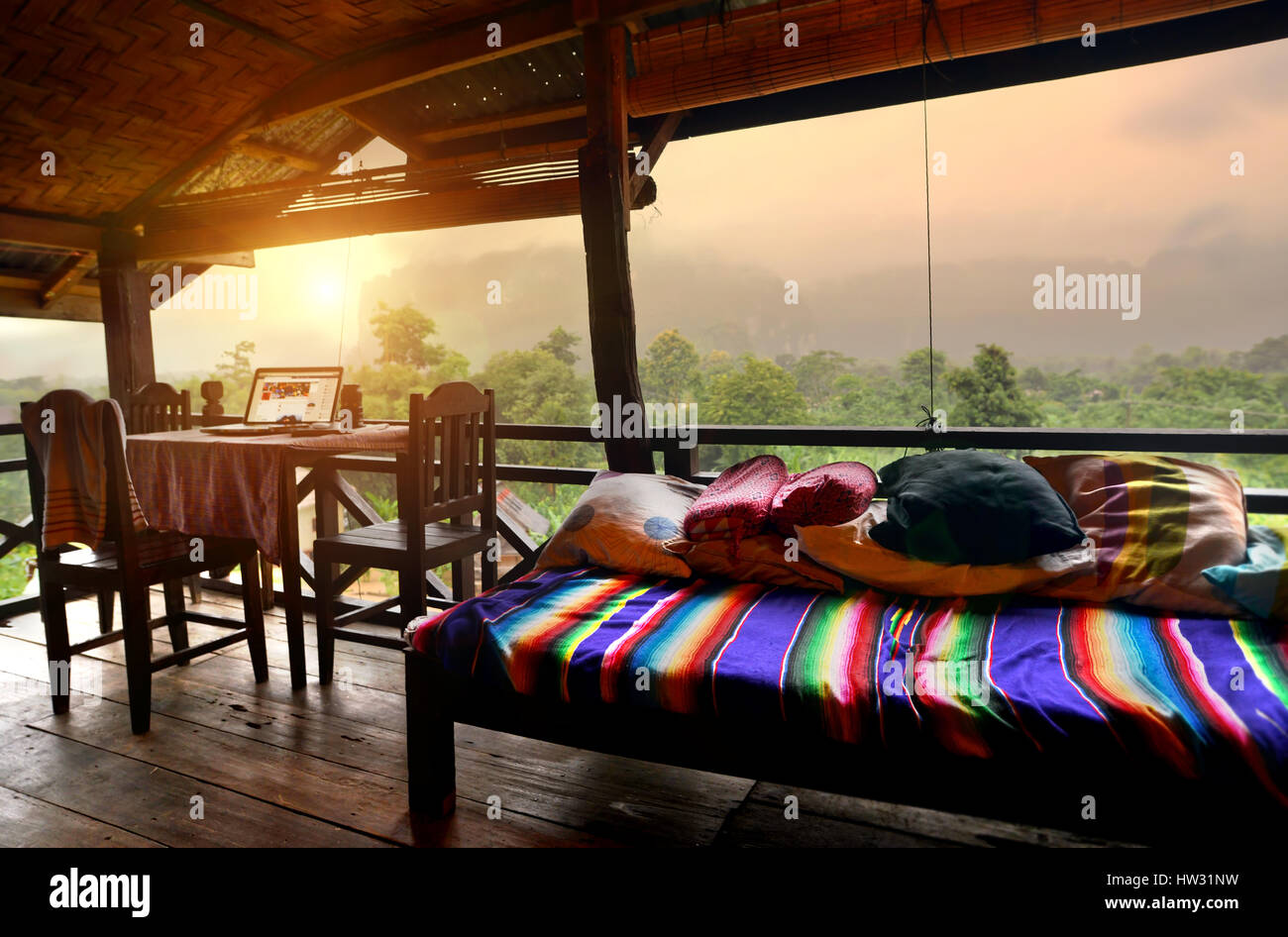 relax balcony at vangvieng the countryside of laos photo indoor dark light and dark shadow the lighting is from outside low light morning Stock Photo
