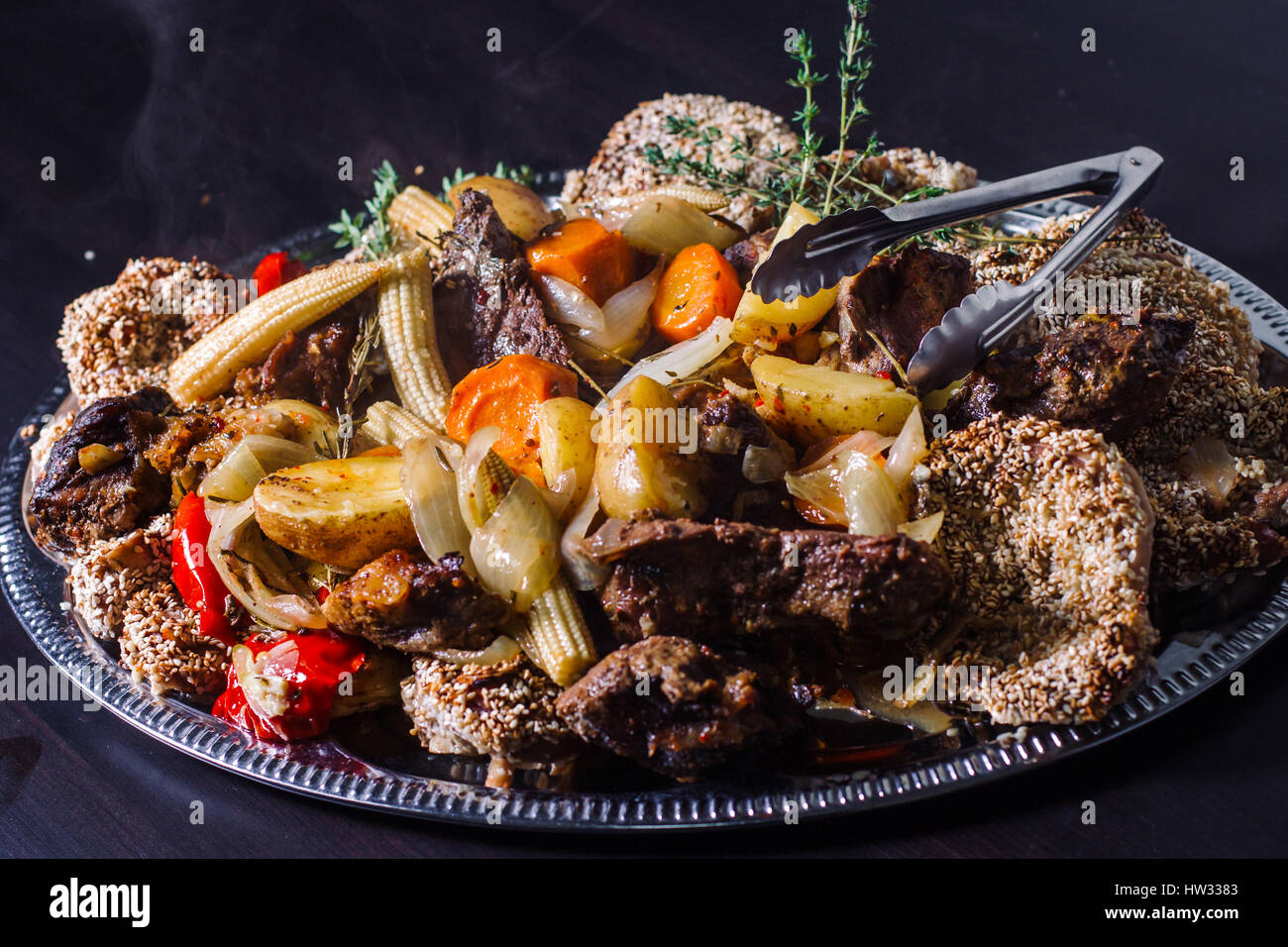 Grilled meat with boiled potatoes and vegetables Stock Photo