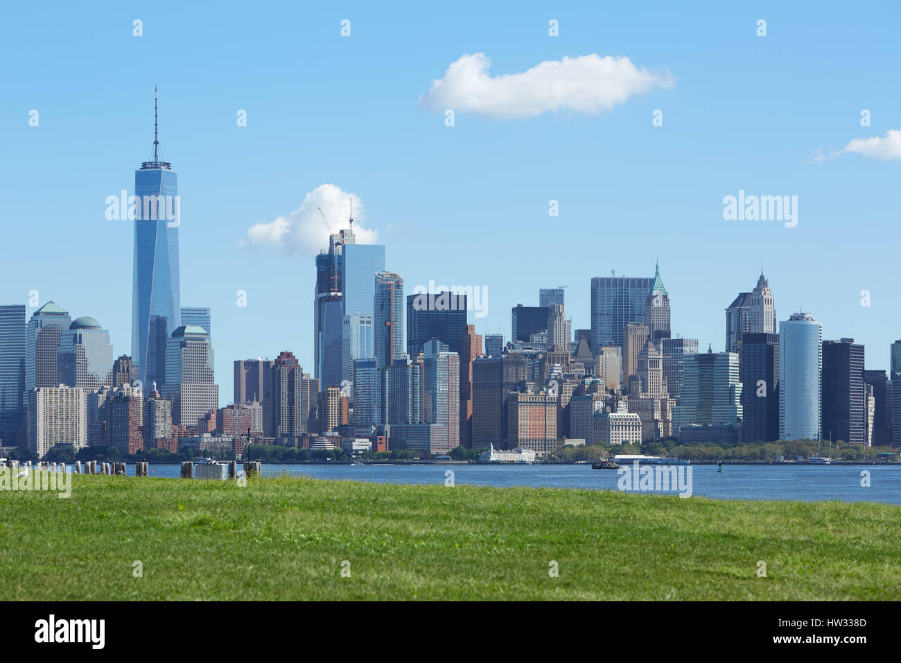 New York city skyline with Liberty tower and green meadow in a sunny day Stock Photo