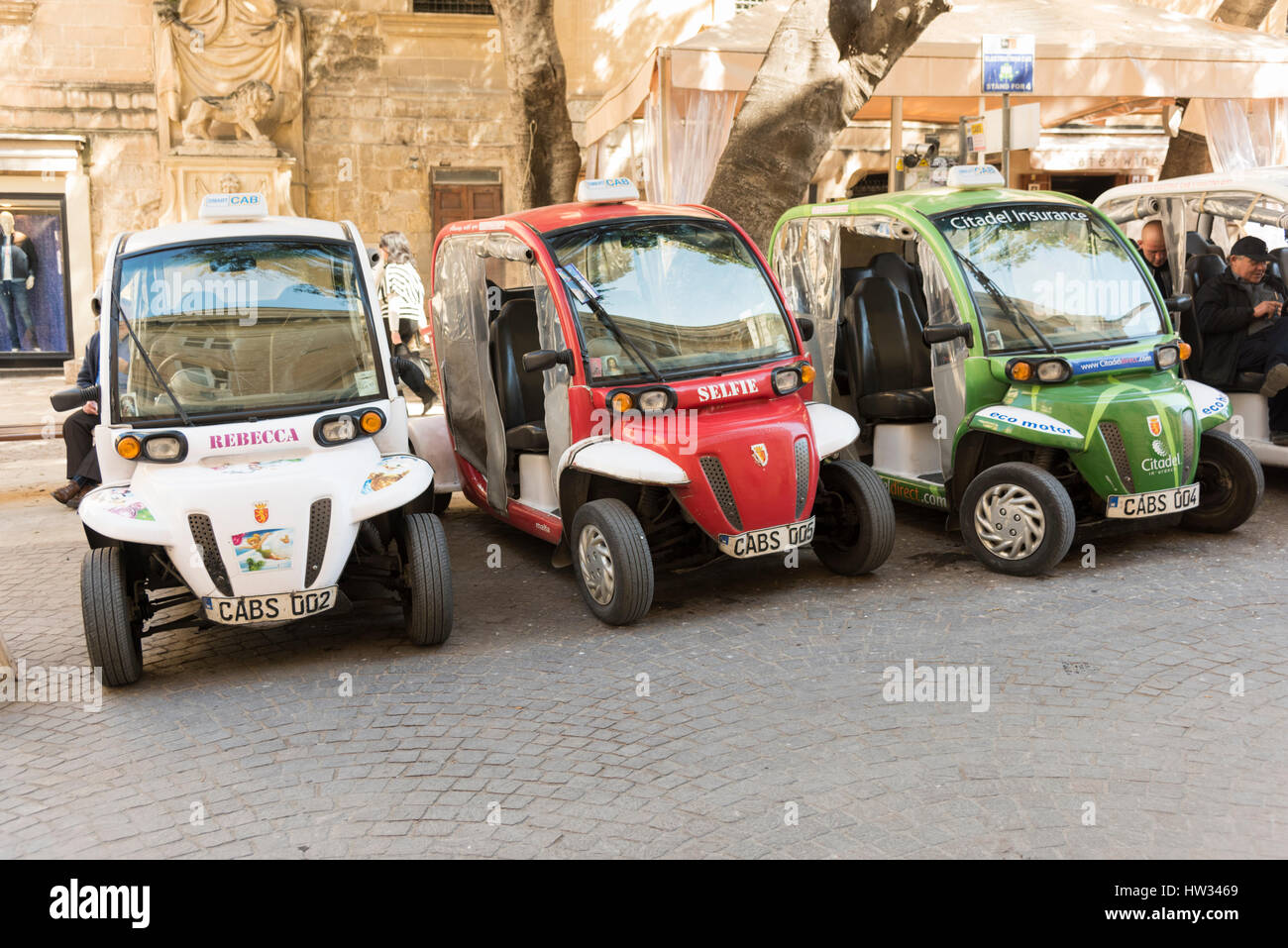 Electric cabs or taxis parked waiting for passengers in the City of Valetta Malta. Green transport solutions in a city. Valetta is the European City o Stock Photo