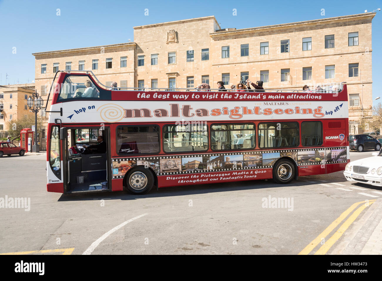 An open top tourist bus in Valetta Malta on a sightseeing tour or trip Stock Photo
