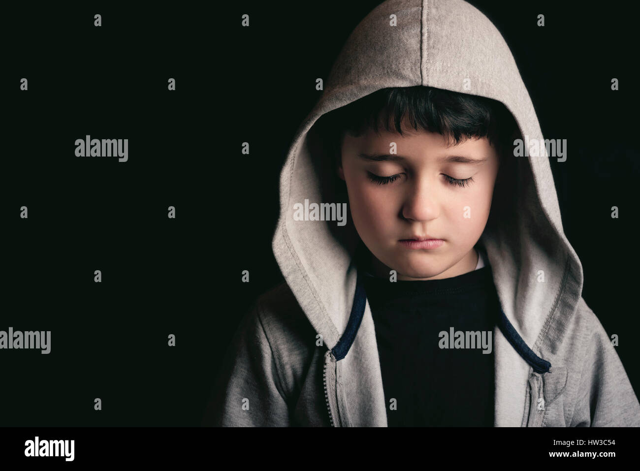 Sad boy on black background Stock Photo Alamy