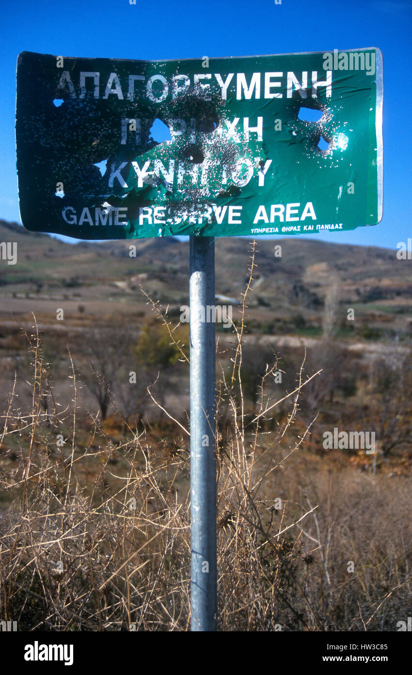 Cyprus. Hunters shoot 'Game Reserve Area sign'       full of holes. Songbirds beware! Stock Photo