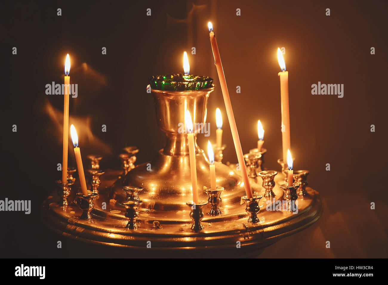 lighting candles in a church Stock Photo Alamy