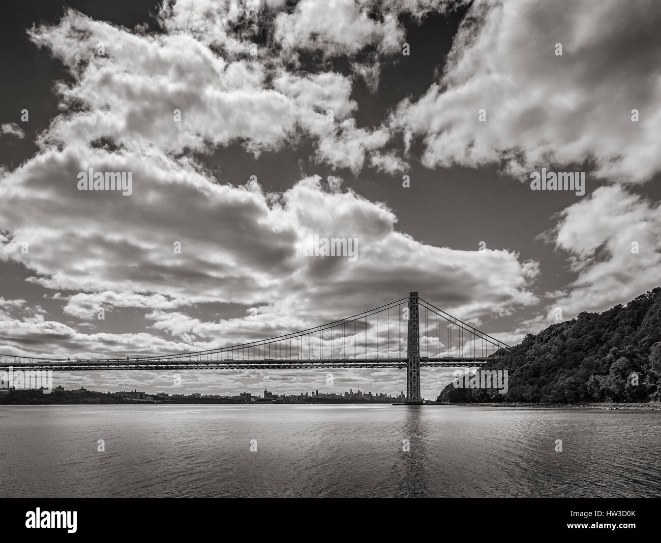 George Washington Bridge spanning Hudson River with clouds in Black & White. New York City Stock Photo
